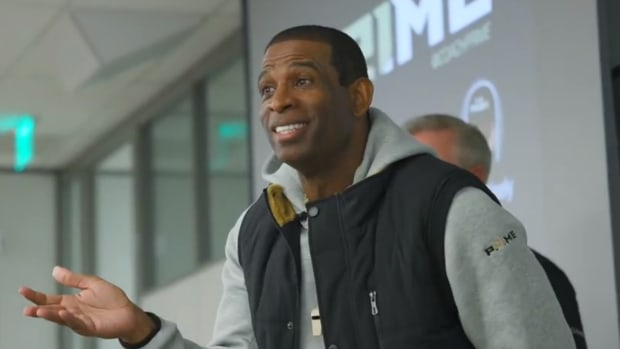 Deion Sanders talking to student at CU Boulder